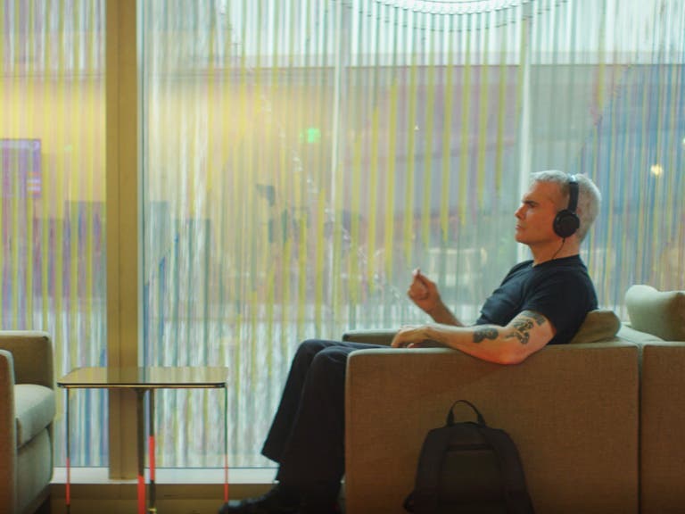 Henry Rollins relaxes with headphones in the Executive Lounge at LAX